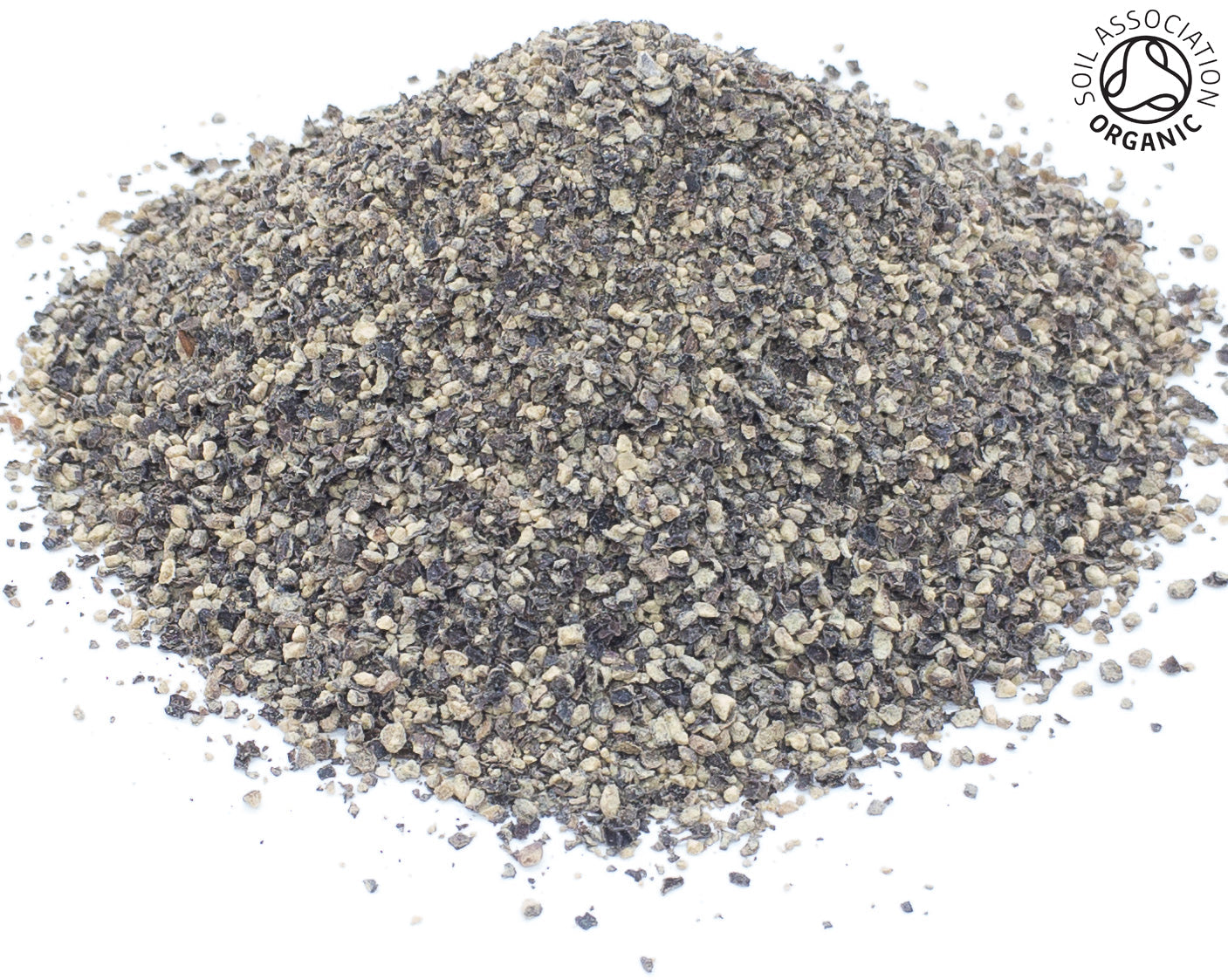 A small pile of organic cut cracked black pepper peppercorns on a white back ground with the Soil Association Organic Logo in the top right corner