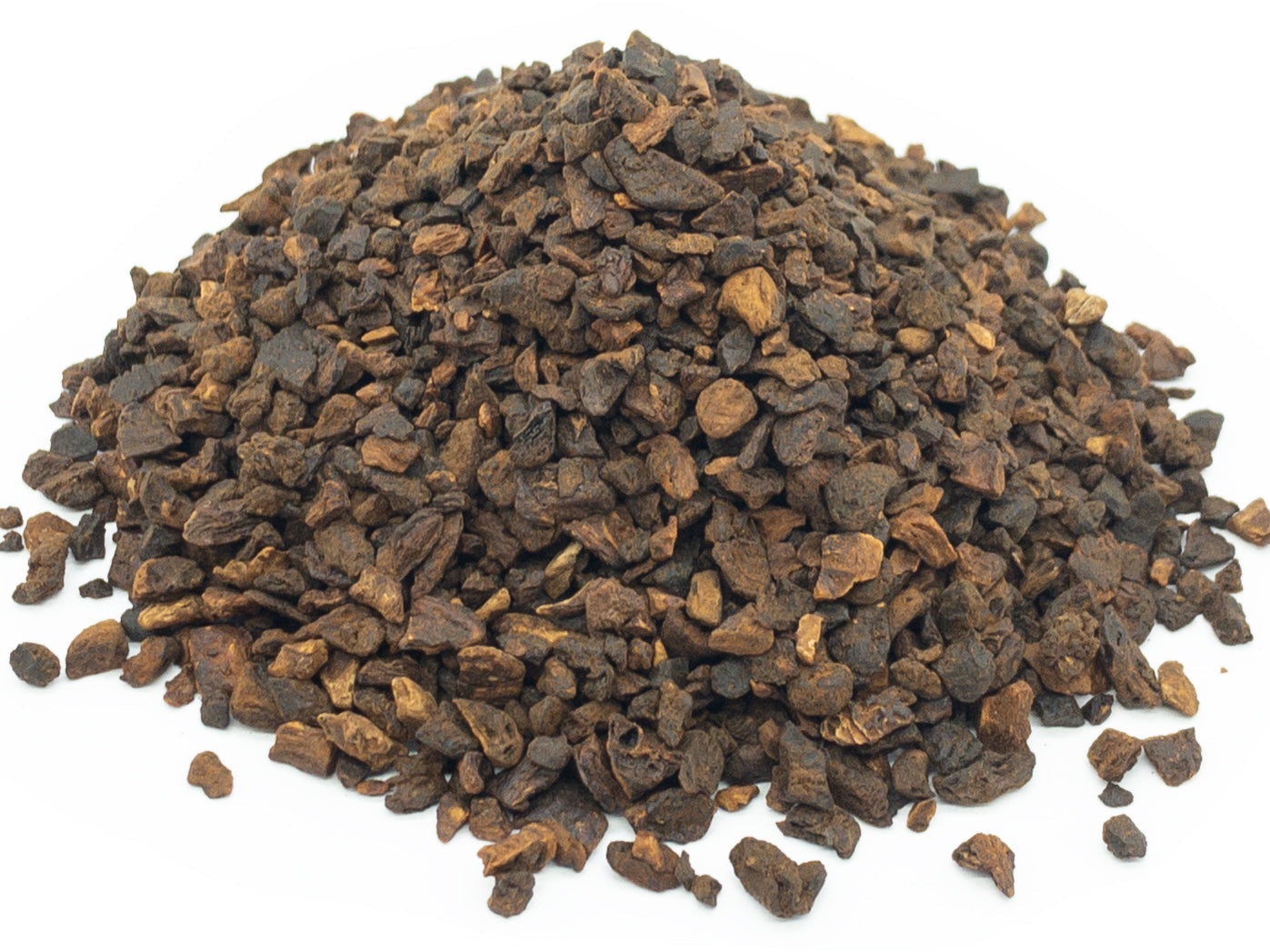 A small pile of dried, cut and roasted dandelion root on a white background