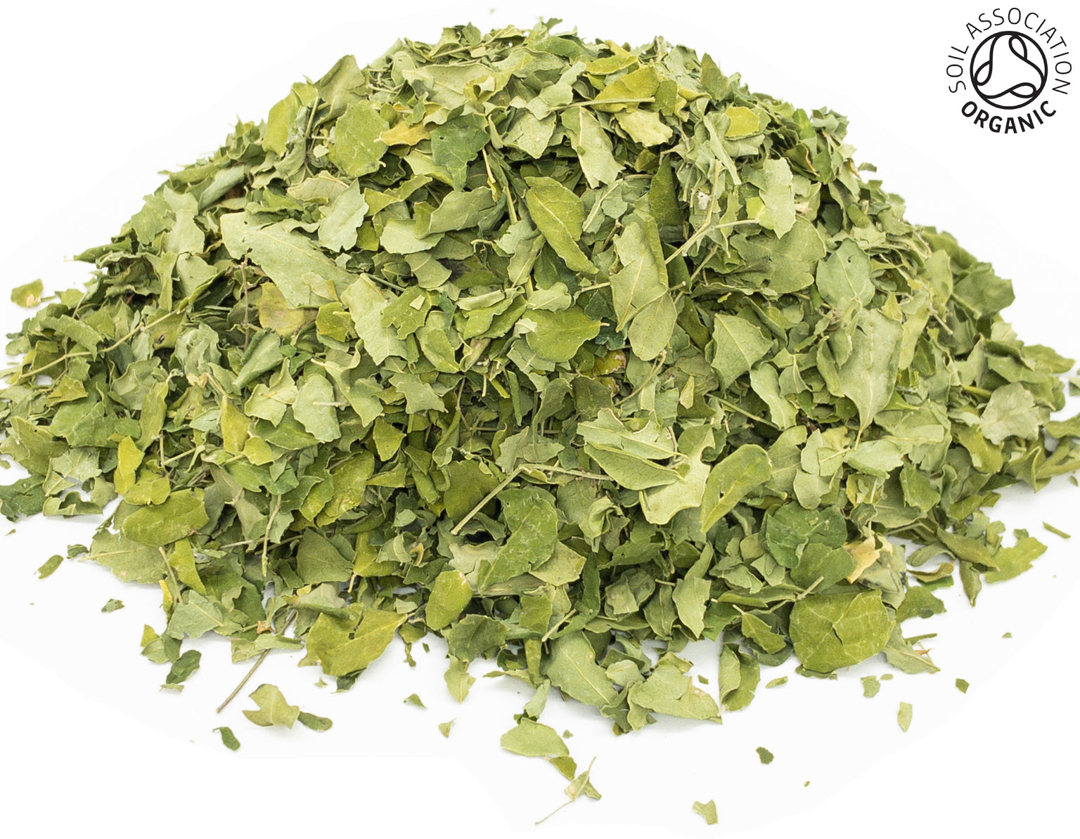 A small pile of dried, cut, organic moringa leaves on a white background with the Soil Association Organic Logo in the top right corner
