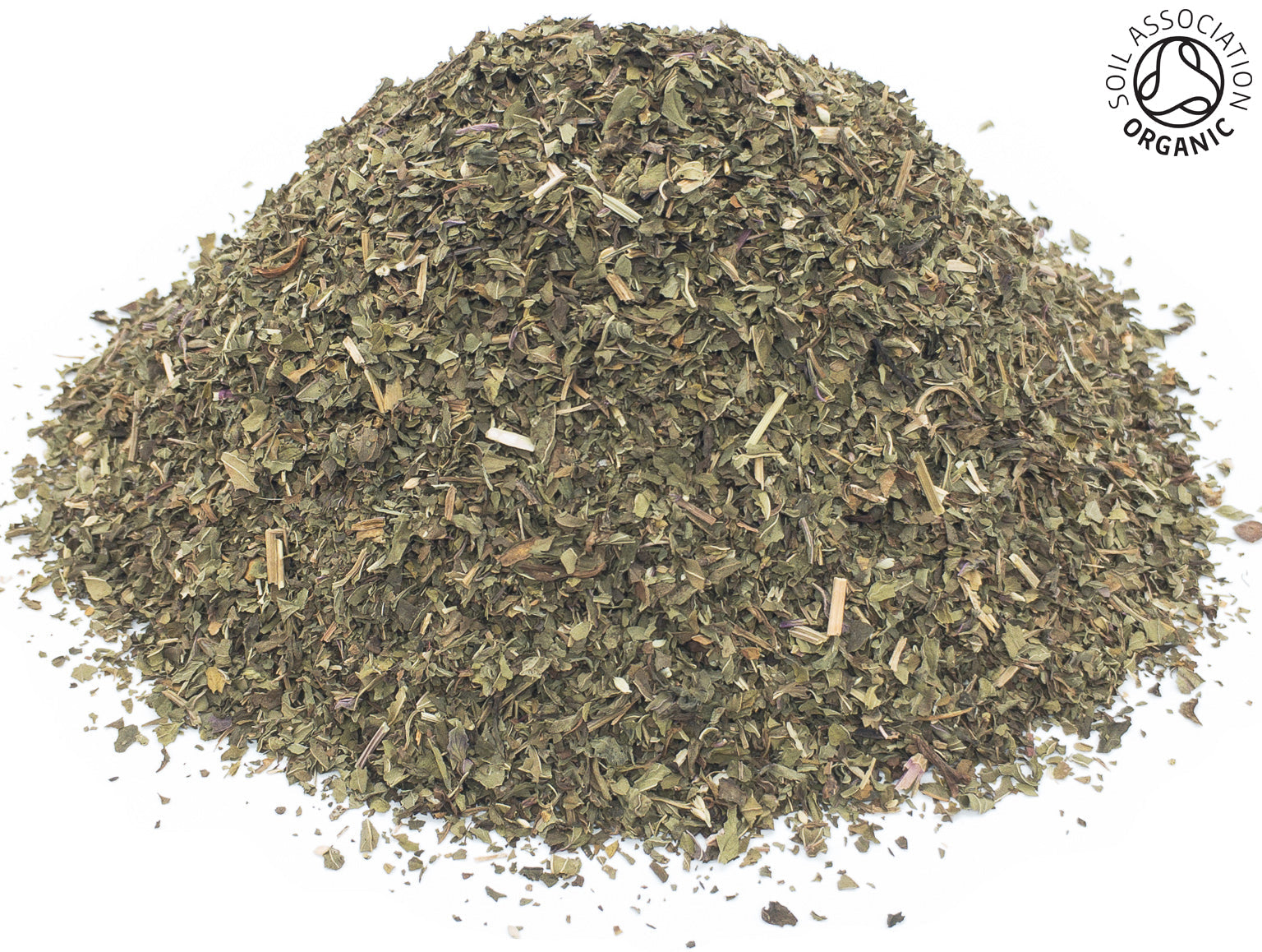 Small pile of dried, cut organic green peppermint leaves on a white background with the Soil Association Organic Logo in the top right corner