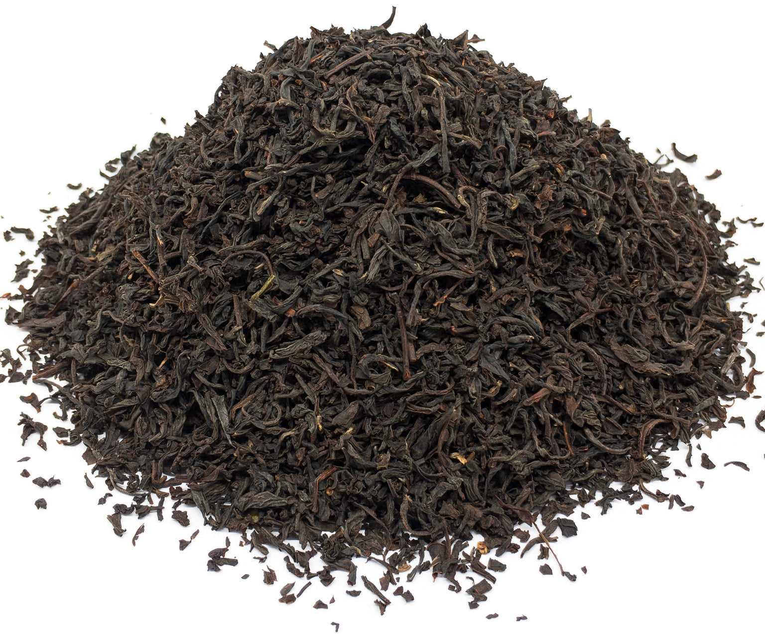 A small pile of dried, russian caravan blend black tea leaves on a white background