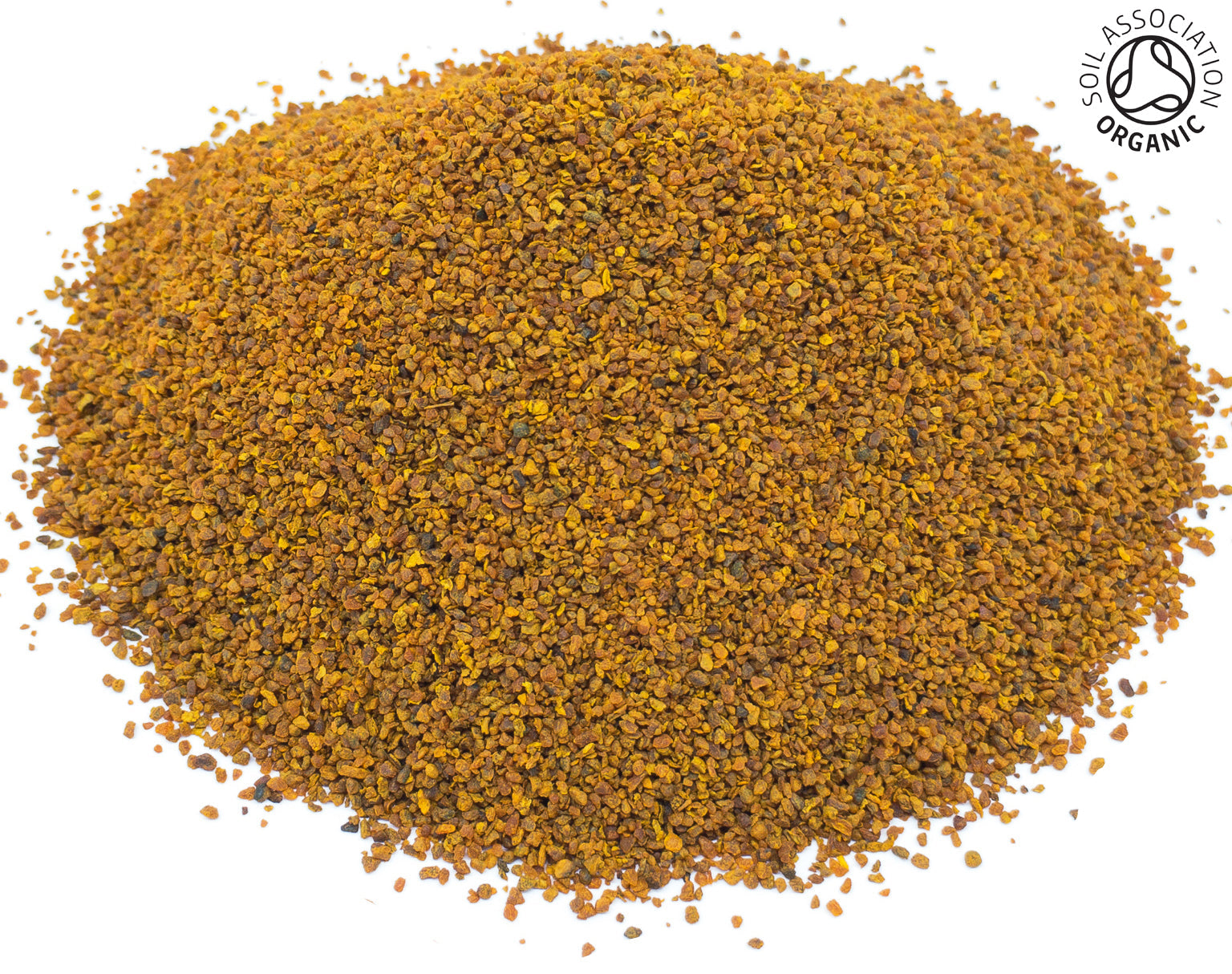 Small pile of dried, cut organic orange turmeric root rhizome root on a white background with the Soil Association Organic Logo in the top right corner