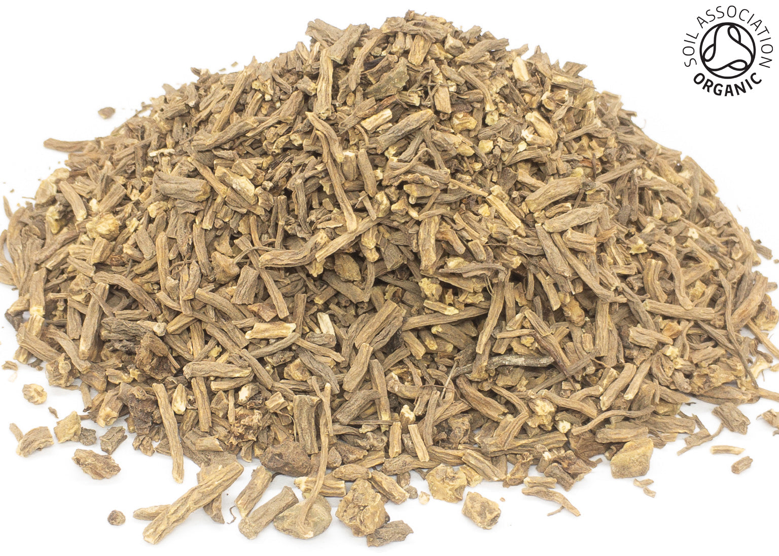 A small pile of dried, cut, organic valerian root light brown on a white background with the Soil Association Organic Logo in the top right corner
