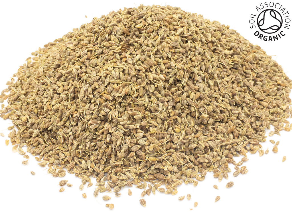 A small pile of dried, whole, organic anise seeds on a white background with the Soil Association Organic Logo in the top right corner