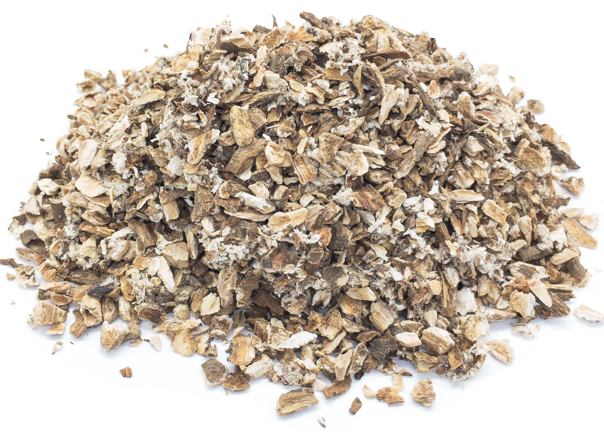 A pile of dried burdock root slices and chunks on a white background