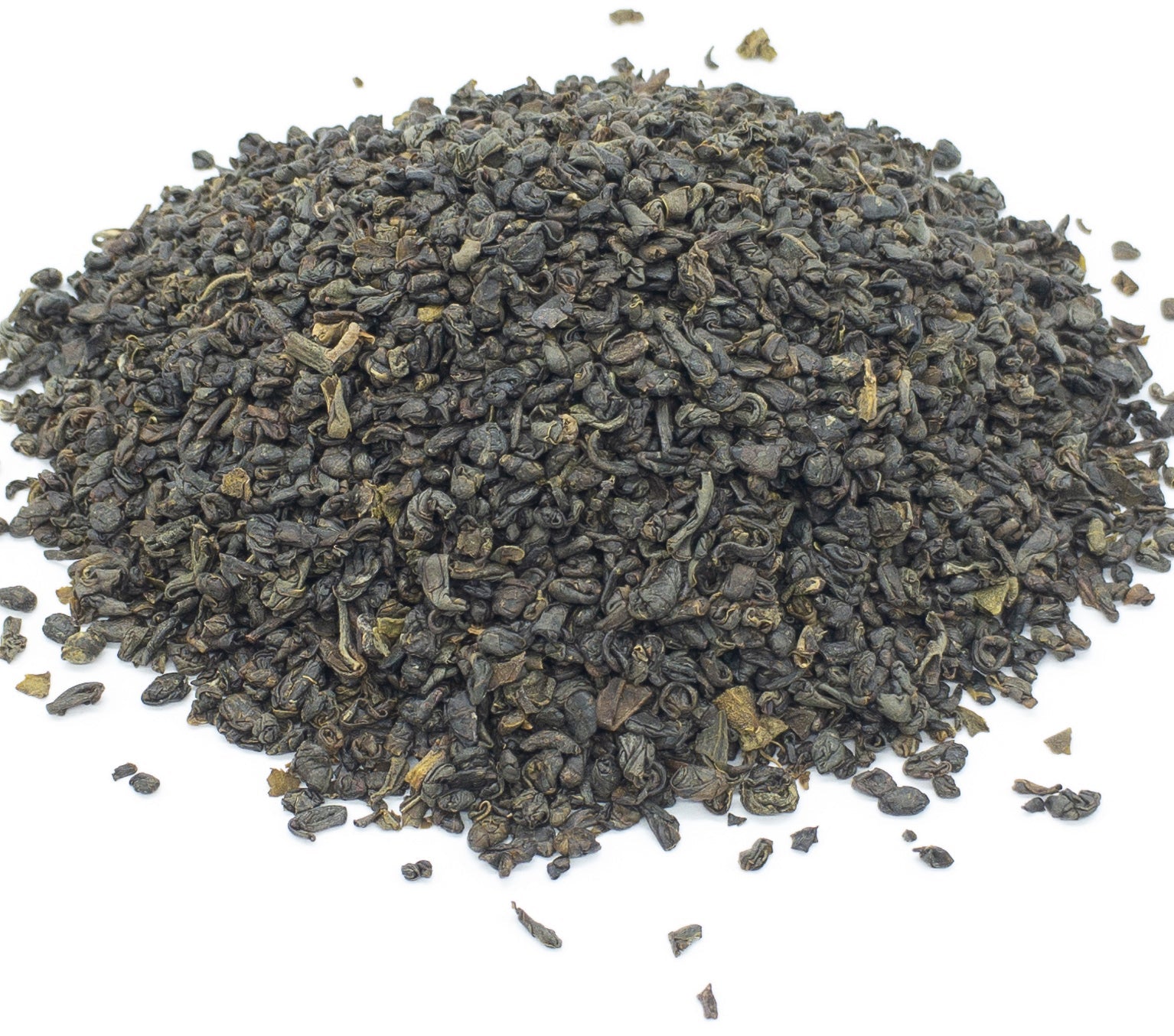 A small pile of dried Ceylon gunpowder style green tea leaves on a white background