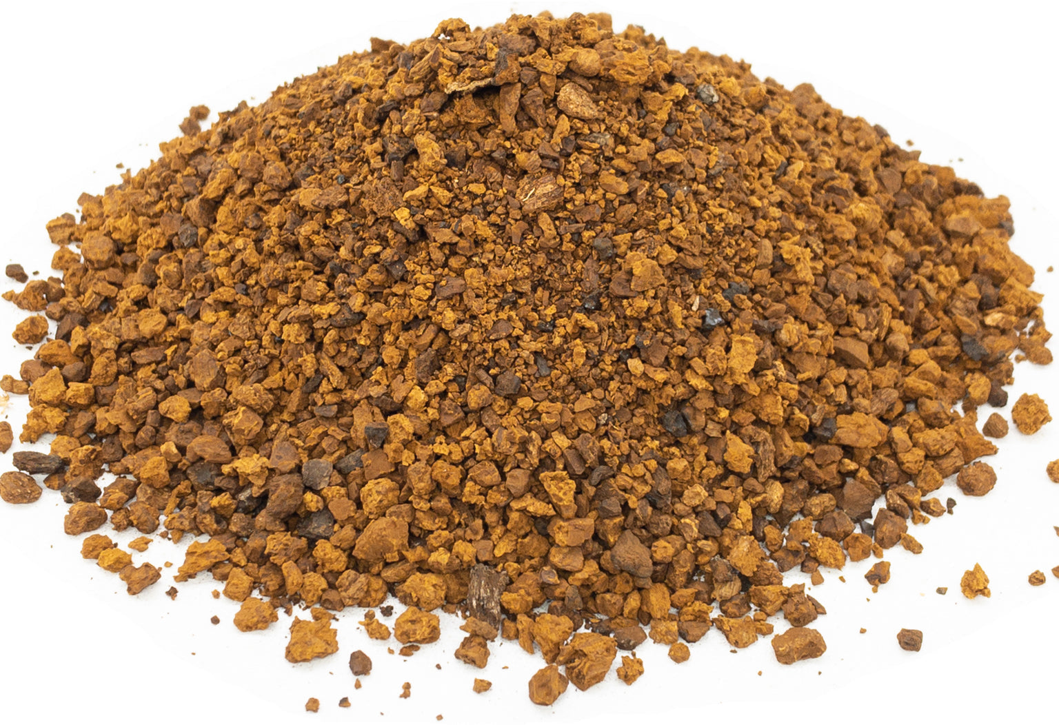 A small pile of dried, cut chaga mushroom pieces on a white background