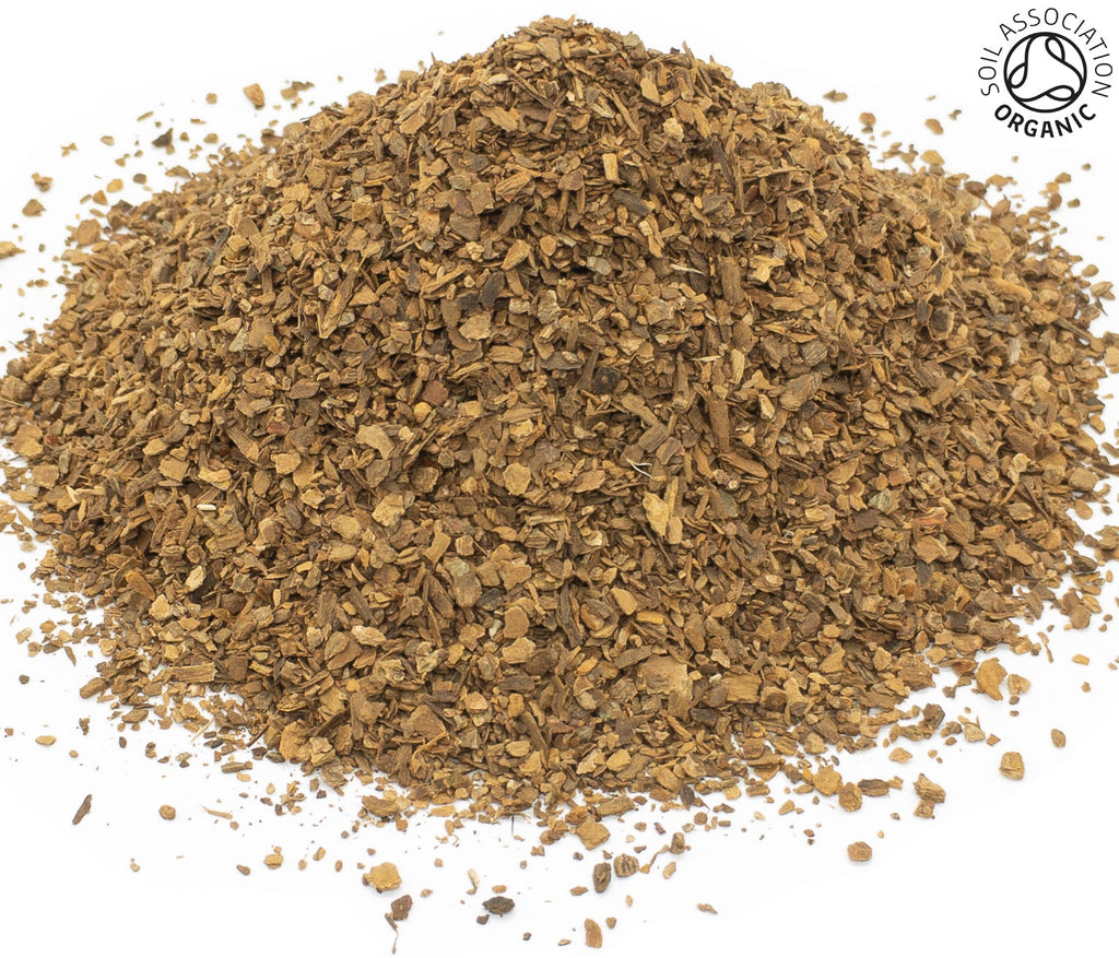 A small pile of dried, cut, organic cinnamon bark brown on a white background with the Soil Association Organic Logo in the top right corner
