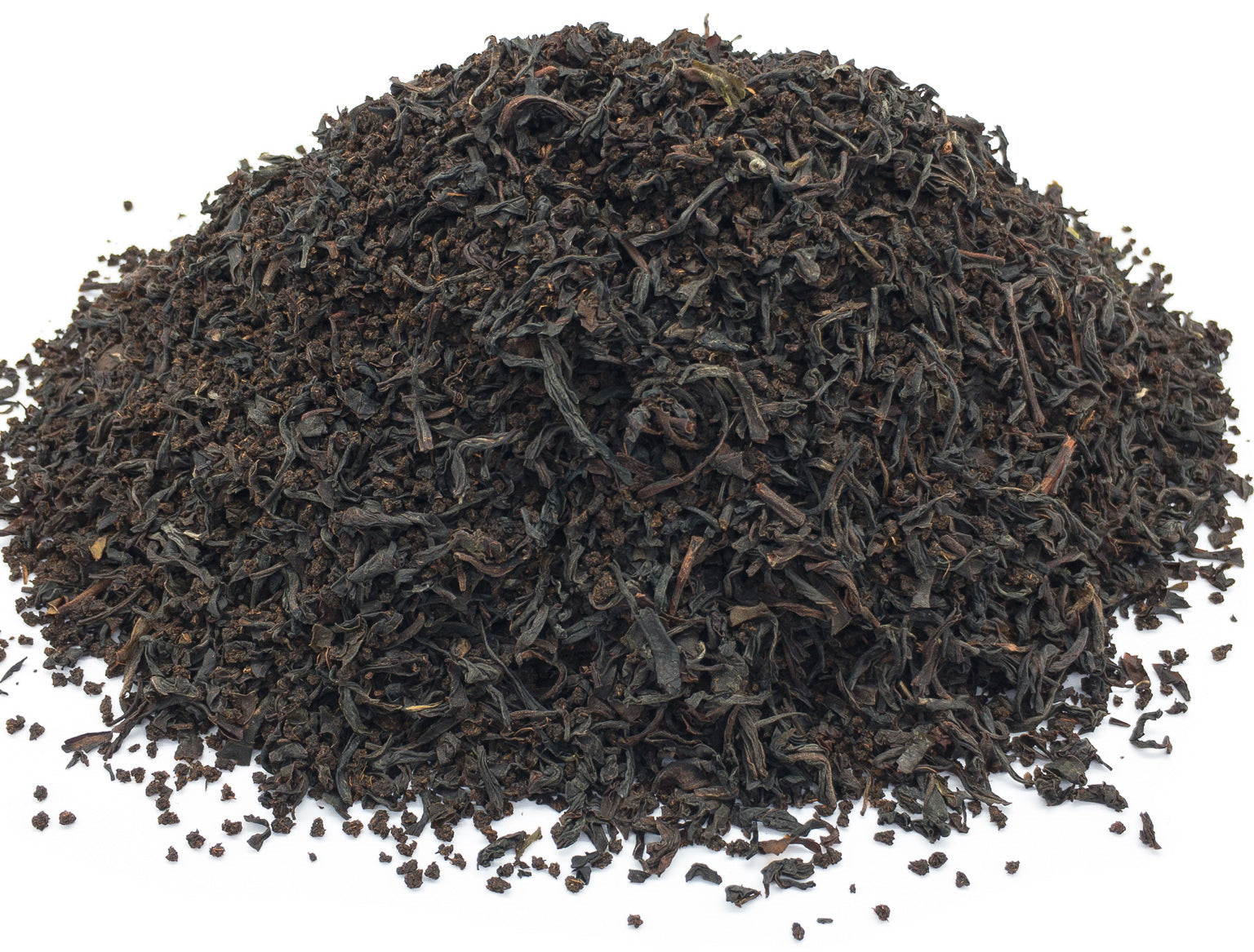 A small pile of dried, blended black tea leaves on a white background