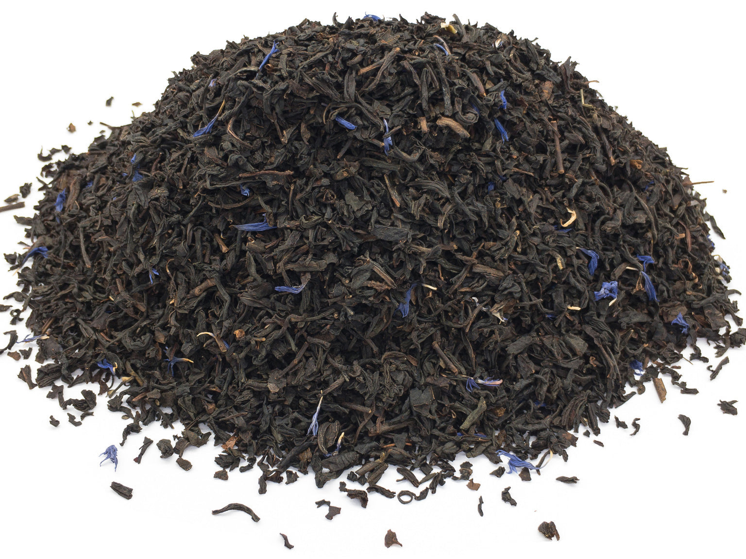 A small pile of dried, earl grey black tea blend on a white backround