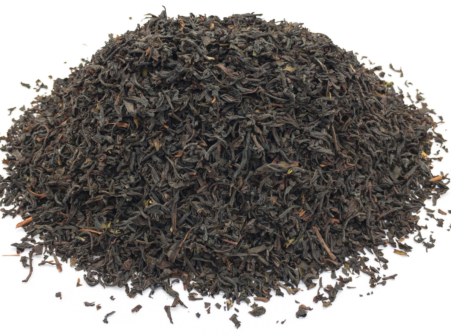 A small pile of dried, english breakfast blend, black tea leaves on a white background