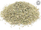 A small pile of whole dried fennel seeds on a white background with the Soil Association Organic Logo in the top right corner
