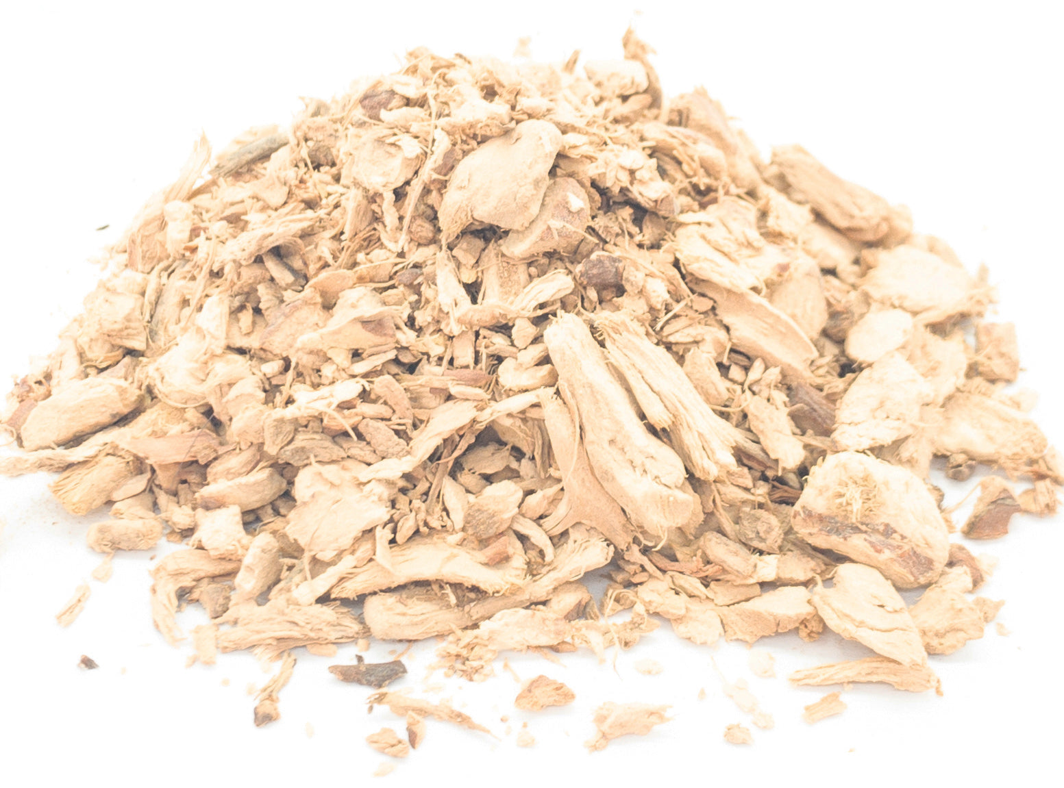 A small pile of dried, cut galangal rhizome on a white background