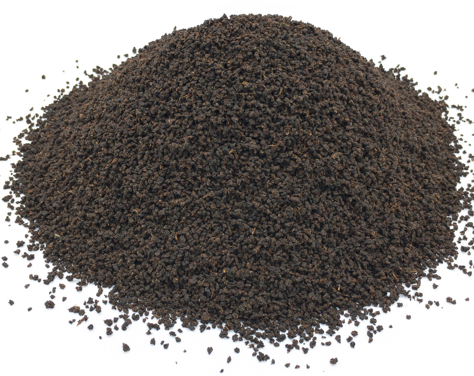 A small pile of dried Irish breakfast blend black tea leaves on a white background
