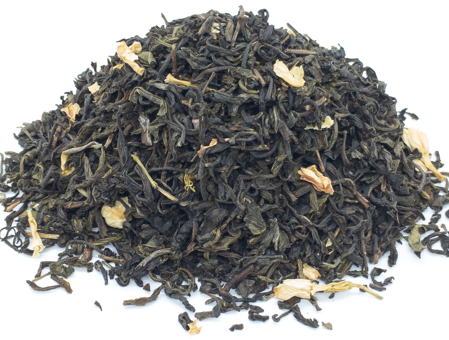 A small pile of dried, jasmine blossom scented green tea leaves on a white background