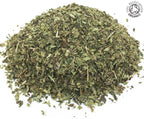 A small heap of cut, dried, organic lemon balm green herb leaf and stem on a white background with the Soil Association Organic Logo in the top right corner
