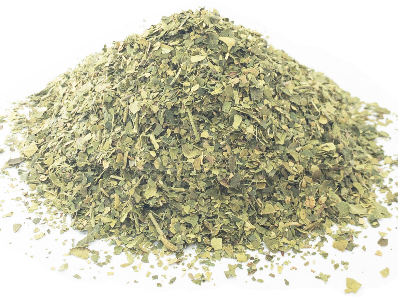 A small pile of dried, cut lime leaves on a white background