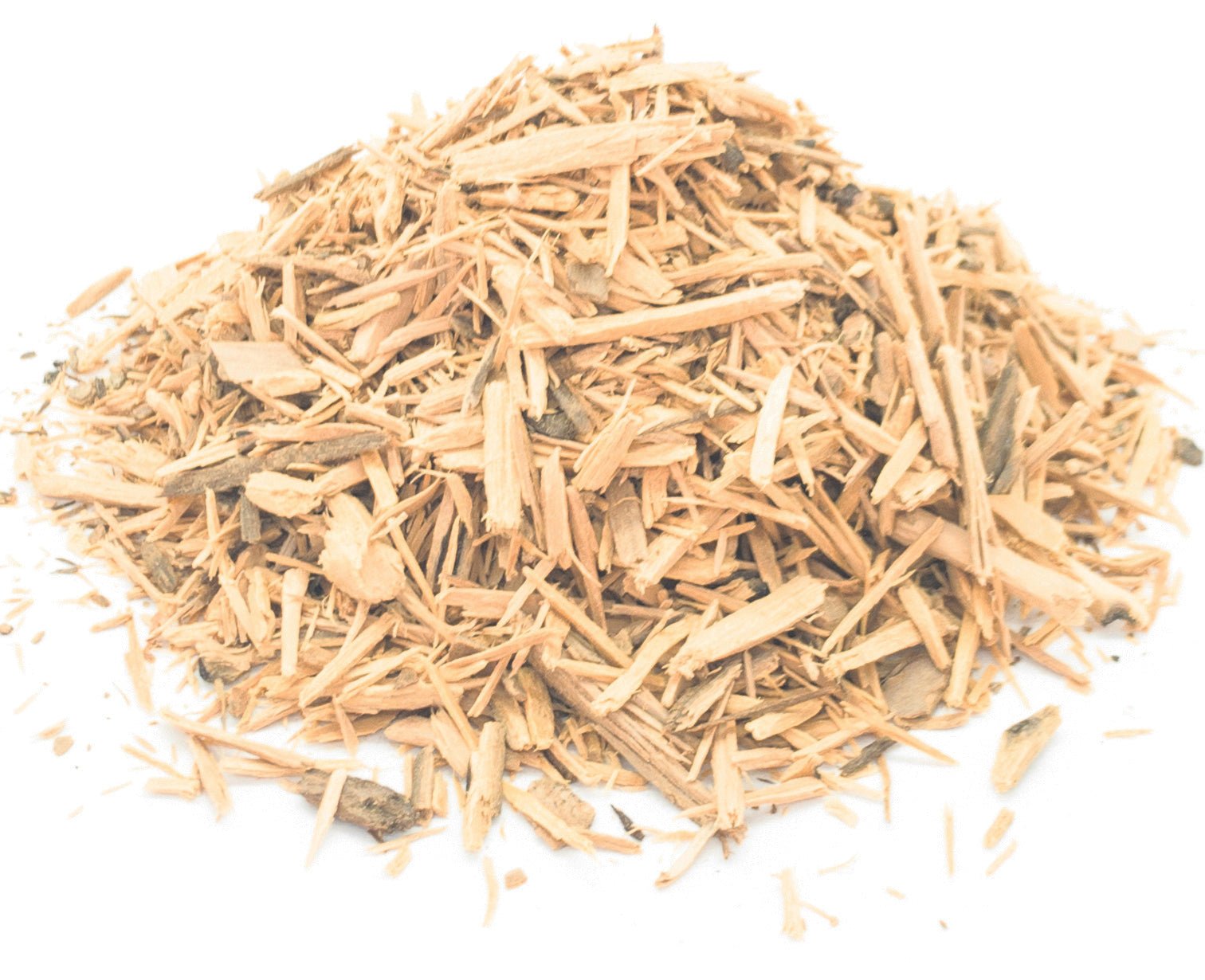 A small pile of dried, cut muira puama bark on a white background