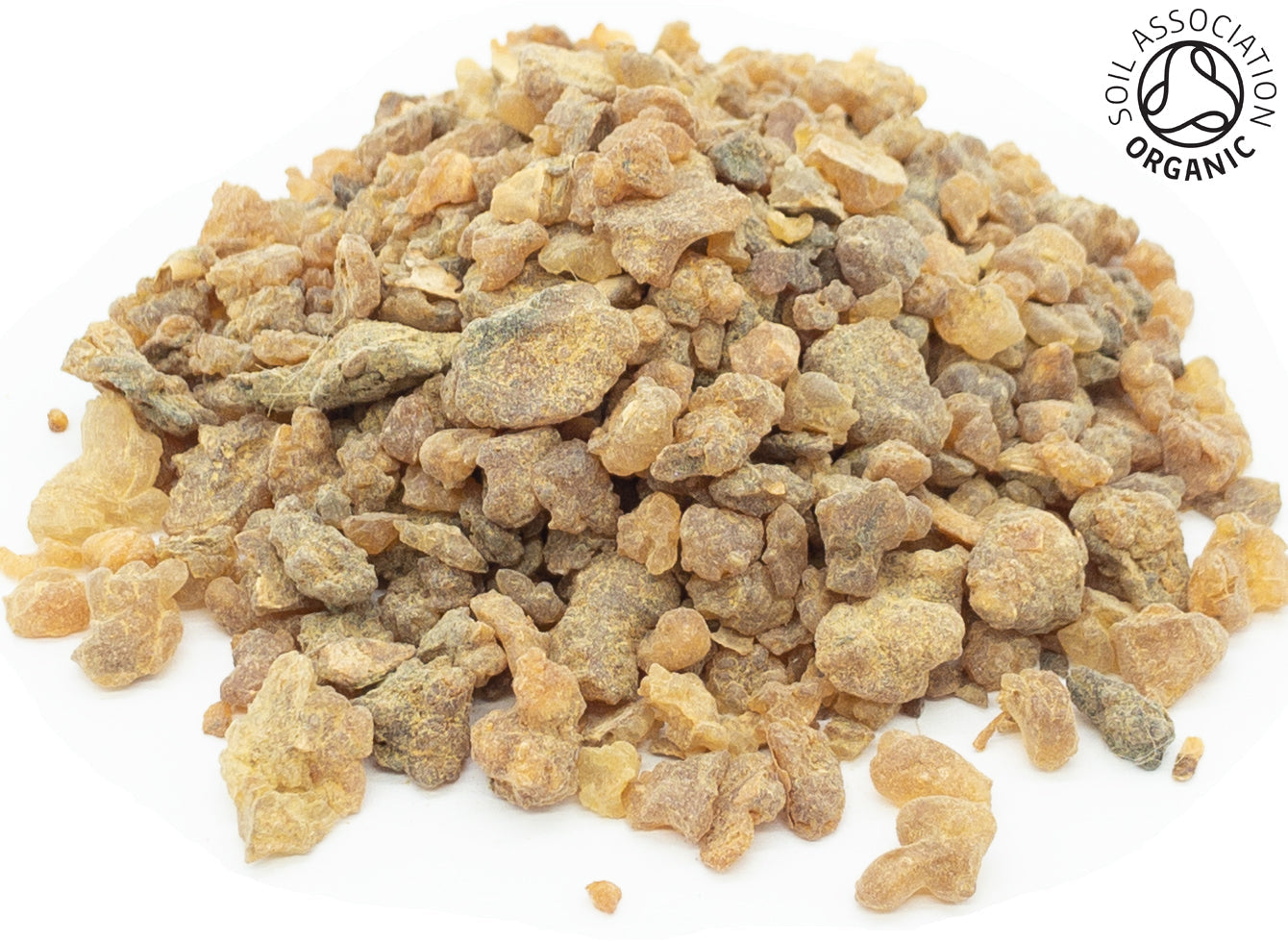 A small pile of organic myrrh resin on a white background with the Soil Association organic logo in the top right had corner