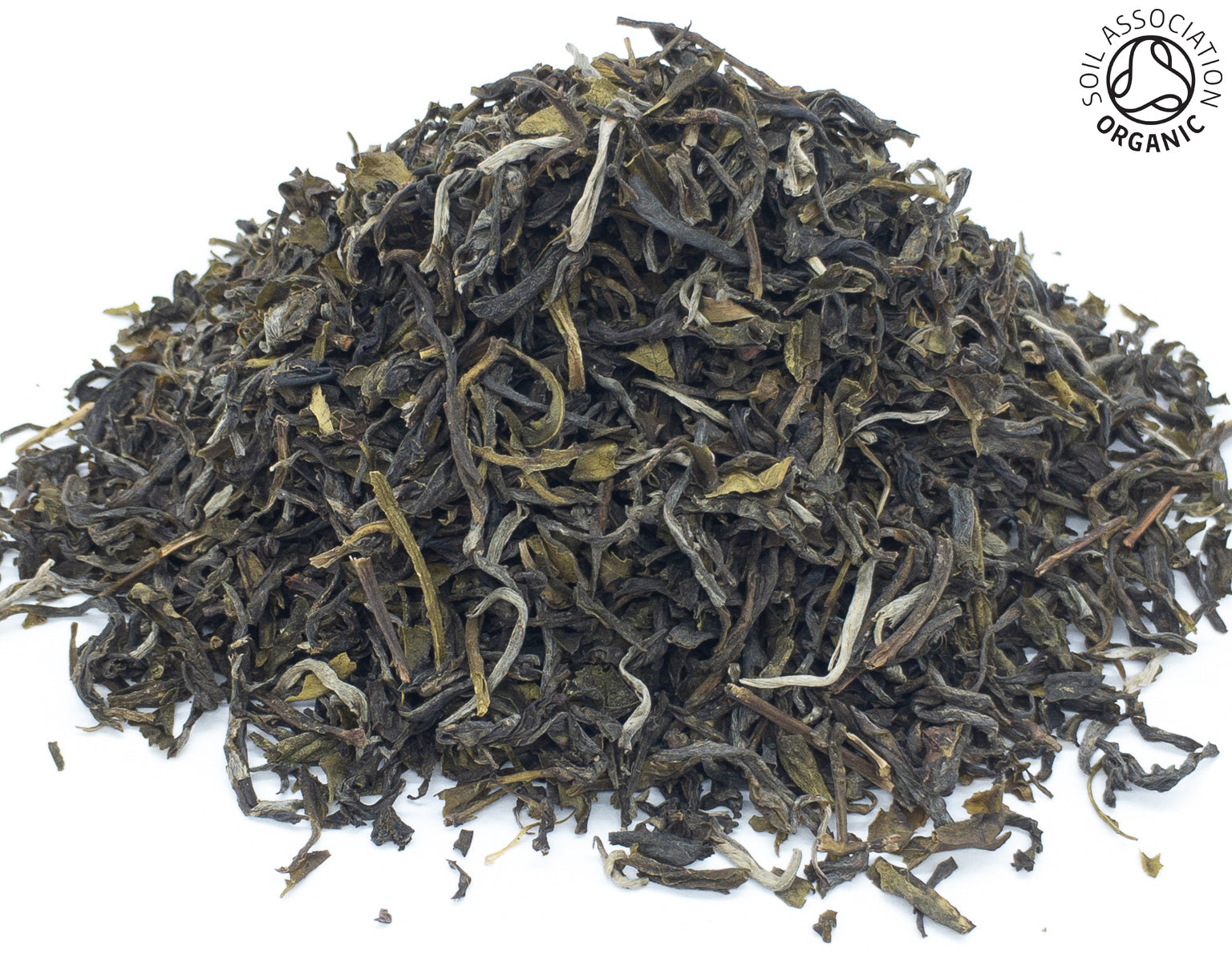 A small pile of dried, pin ho jade organic green tea leaves on a white background