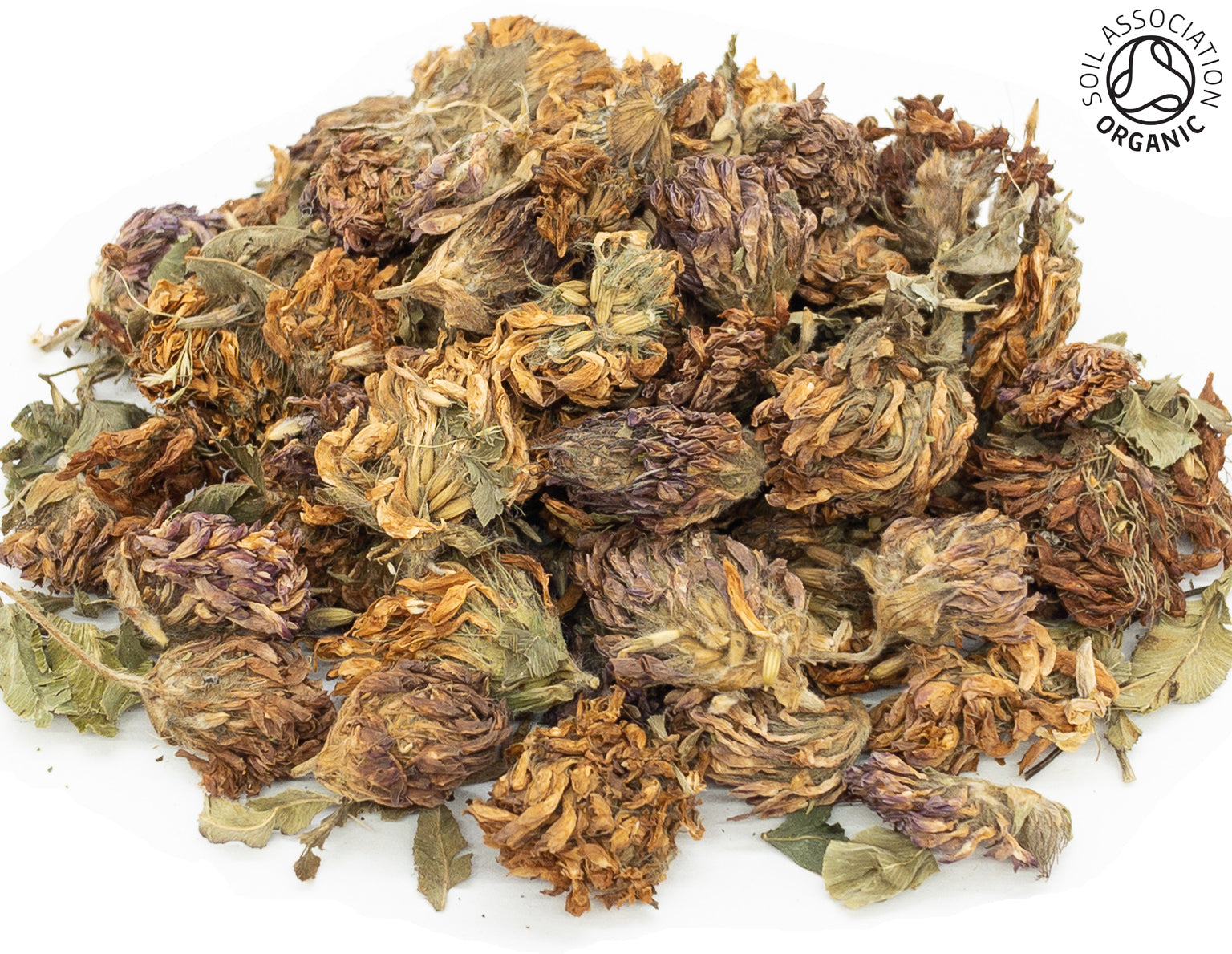 A small pile of dried, organic red clover flowers on a white background with the Soil Association Organic Logo in the top right corner