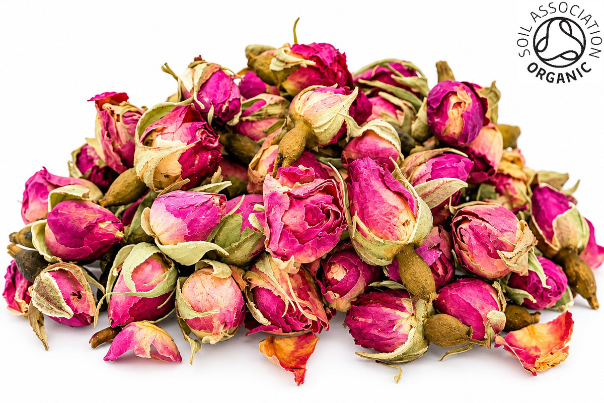 A small pile of organic pink rose buds on a white background with the Soil Association organic logo in the top right hand corner
