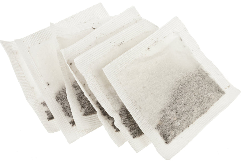 Unbleached Tea bags with visible tea leaves on a white background
