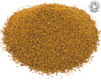 Small pile of dried, cut organic orange turmeric root rhizome root on a white background with the Soil Association Organic Logo in the top right corner